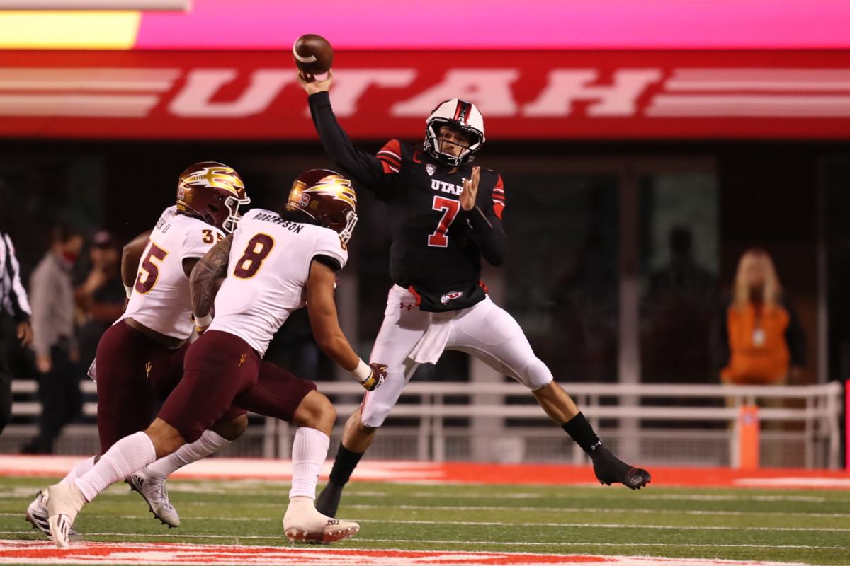Utah quarterback Cameron Rising (7) throws a pass under pressure against Arizona State.